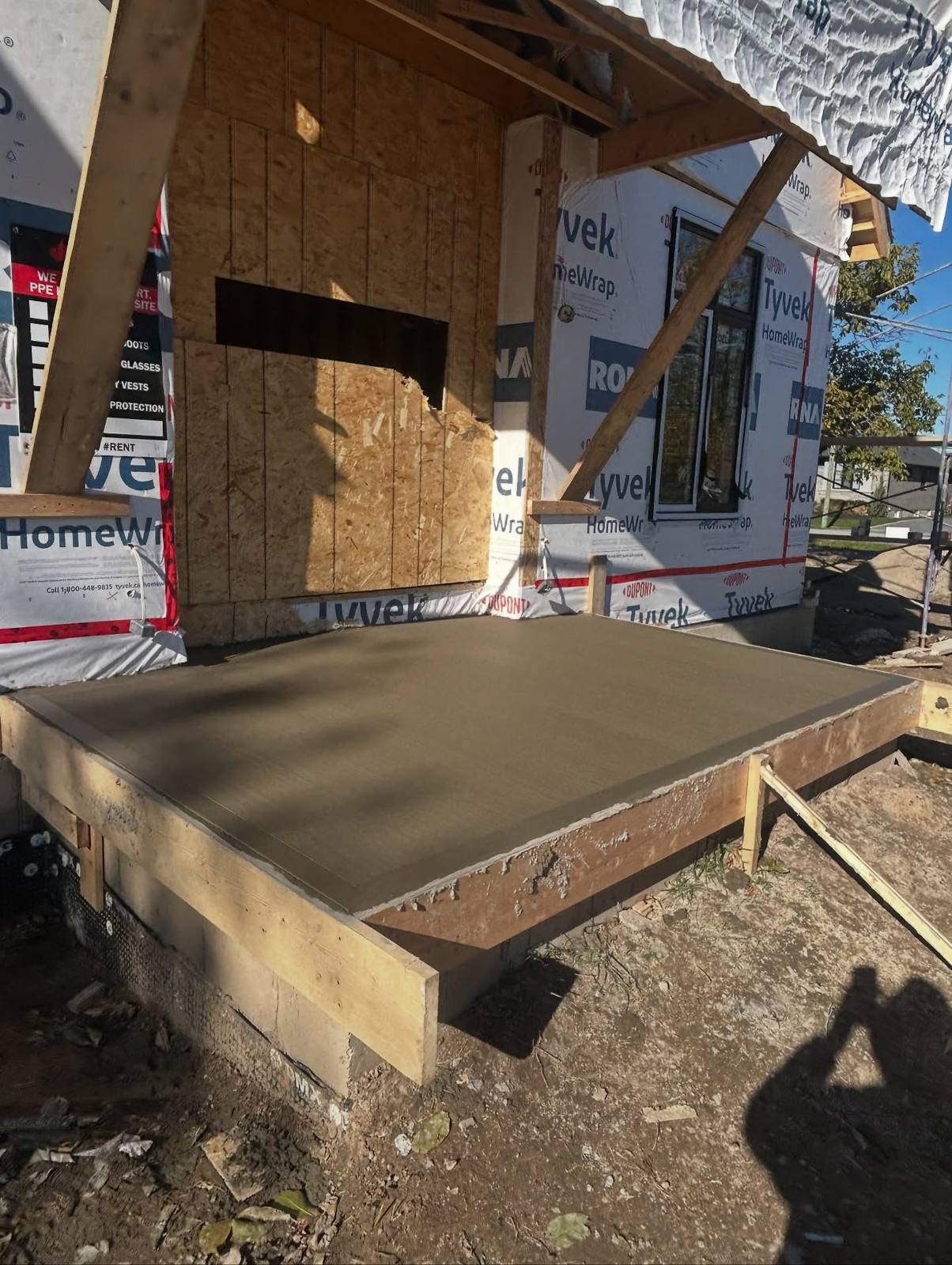 Freshly poured concrete porch slab on a new build